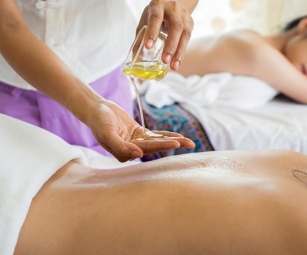 Massage therapist treating patient